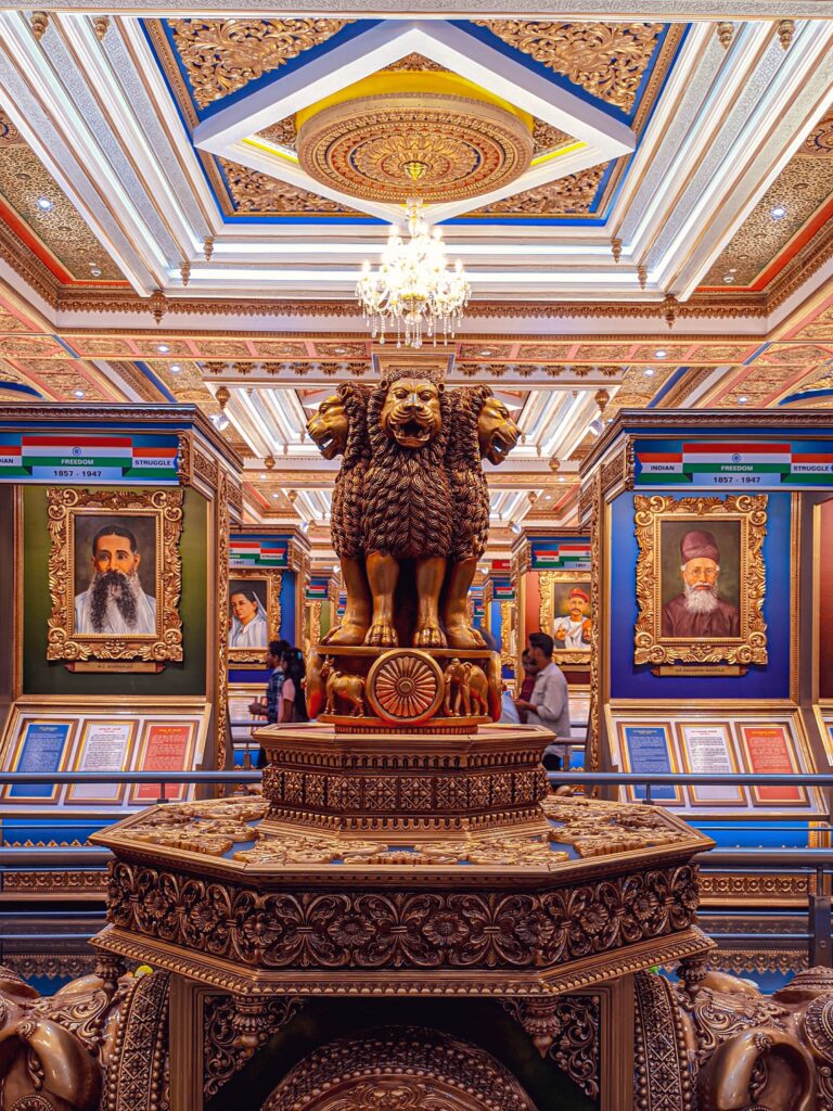 Intricate museum hall featuring a lion statue and vibrant portraits. Architectural splendor captured indoors.
